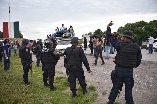 Agentes de seguridad registran a los manifestantes