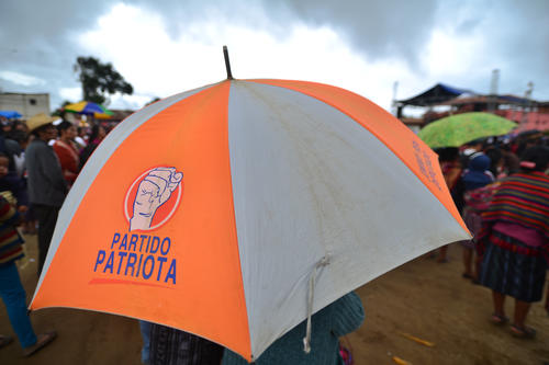 Varias personas llevaban sombrillas del partido Patriota al mitin de Jimmy Morales. (Foto: Wilder López/Soy502)