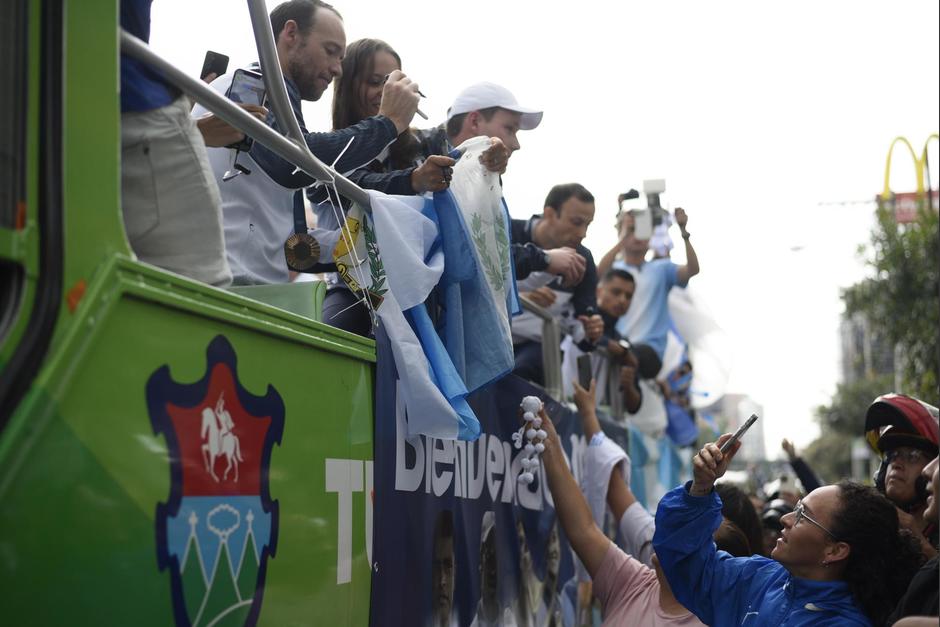 Una mujer se acerca para entregarle un regalo especial hecho a mano a la ganadora de la medalla de oro. (Foto: Wilder López/Soy502)