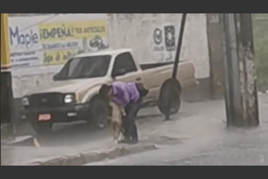 Captan la tierna acción de un hombre para evitar que su perro atraviese una inundación. (Foto: captura de video)